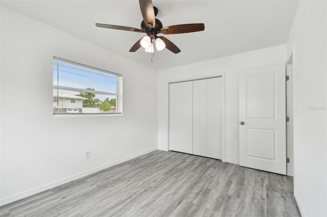 2401 Havana Dr, Clearwater, FL 33764 - unfurnished bedroom with wood finished floors, ceiling fan, a closet, and baseboards