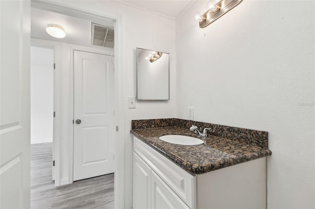 2401 Havana Dr, Clearwater, FL 33764 - bathroom featuring vanity, visible vents, and wood finished floors