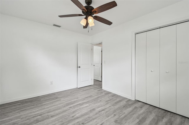 2401 Havana Dr, Clearwater, FL 33764 - unfurnished bedroom with visible vents, baseboards, a closet, ceiling fan, and wood finished floors