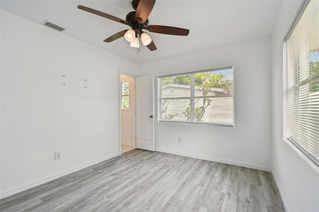 2401 Havana Dr, Clearwater, FL 33764 - empty room with wood finished floors, ceiling fan, baseboards, and visible vents