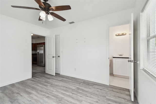 2401 Havana Dr, Clearwater, FL 33764 - unfurnished bedroom featuring visible vents, baseboards, stainless steel refrigerator with ice dispenser, and light wood-style floors
