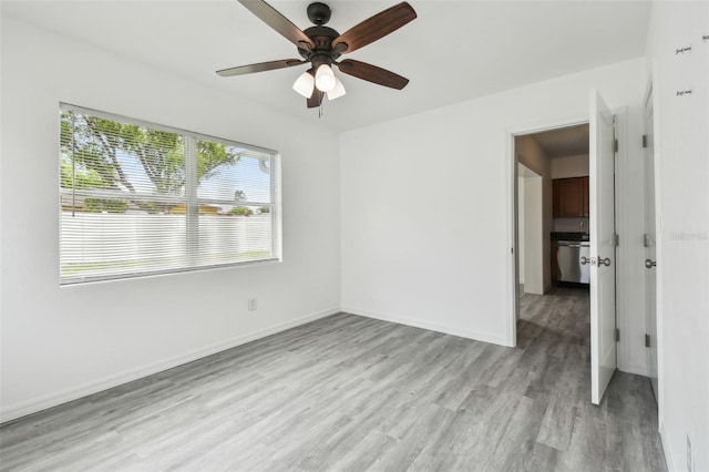 2401 Havana Dr, Clearwater, FL 33764 - unfurnished bedroom featuring ceiling fan, light wood finished floors, and baseboards
