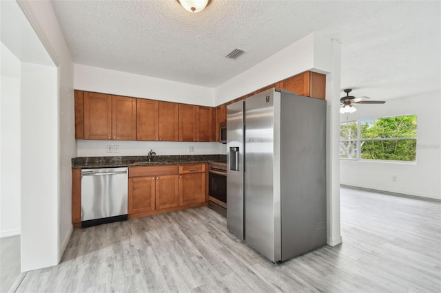 2401 Havana Dr, Clearwater, FL 33764 - kitchen with appliances with stainless steel finishes, light wood finished floors, a sink, and visible vents