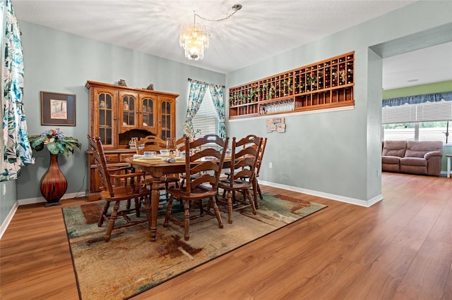 3434 Tarbolton Way, Land O Lakes, FL 34638 - dining room with baseboards, wood finished floors, and a notable chandelier