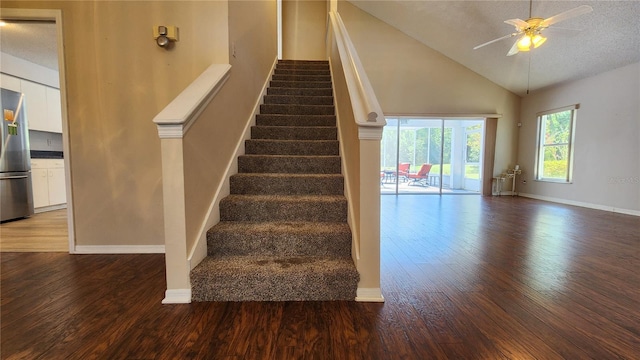 stairway featuring a textured ceiling, wood finished floors, baseboards, and a ceiling fan