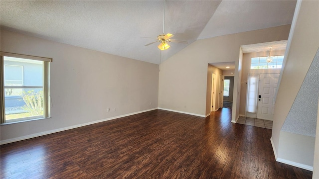 entryway with plenty of natural light, lofted ceiling, ceiling fan, and wood finished floors