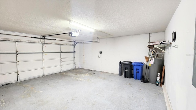 garage featuring water heater and a garage door opener