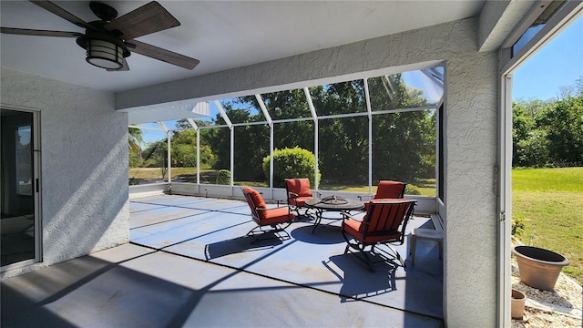 sunroom with a ceiling fan