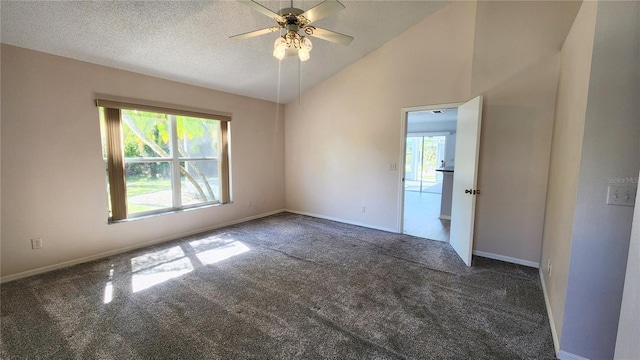 carpeted empty room with a textured ceiling, baseboards, a ceiling fan, and vaulted ceiling