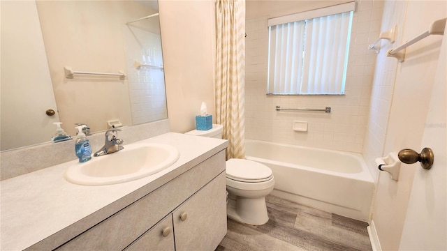 bathroom with shower / bath combo with shower curtain, vanity, toilet, and wood finished floors
