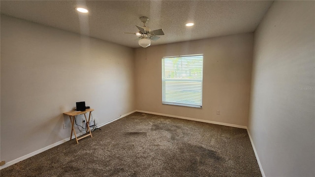 empty room with a textured ceiling, ceiling fan, baseboards, and carpet flooring