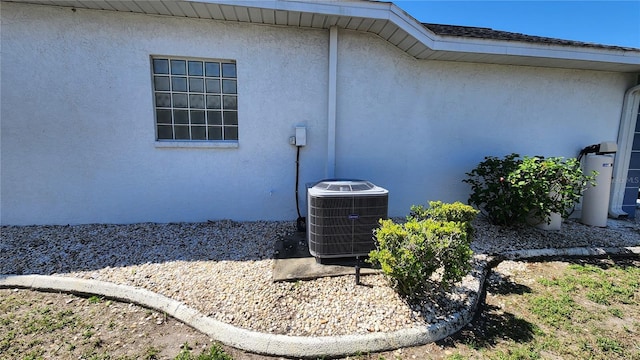 view of home's exterior featuring central air condition unit and stucco siding