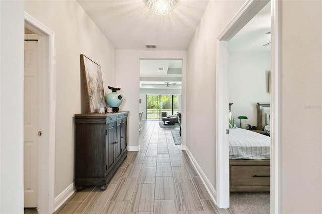 19325 Hawk Valley Dr, Tampa, FL 33647 - hallway with wood tiled floor, visible vents, and baseboards