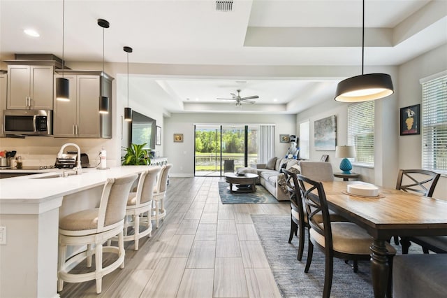 19325 Hawk Valley Dr, Tampa, FL 33647 - dining area with visible vents, a tray ceiling, baseboards, recessed lighting, and a ceiling fan