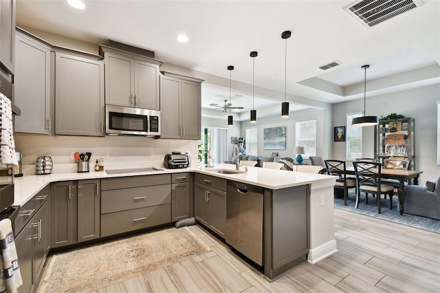 19325 Hawk Valley Dr, Tampa, FL 33647 - kitchen with appliances with stainless steel finishes, visible vents, and gray cabinetry