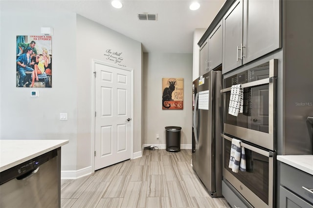 19325 Hawk Valley Dr, Tampa, FL 33647 - kitchen featuring visible vents, stainless steel appliances, baseboards, recessed lighting, and gray cabinets