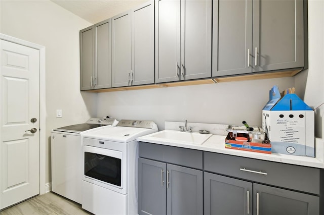 19325 Hawk Valley Dr, Tampa, FL 33647 - washroom with separate washer and dryer, cabinet space, and a sink