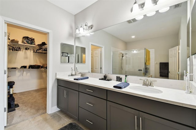 19325 Hawk Valley Dr, Tampa, FL 33647 - bathroom featuring a sink, a shower stall, double vanity, visible vents, and a spacious closet