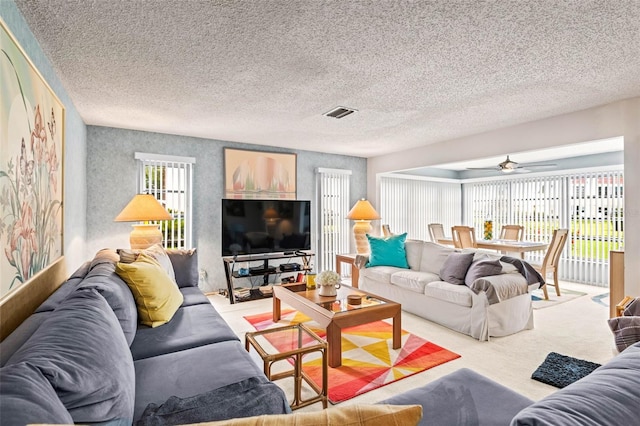 101 Dogwood Cir, Seminole, FL 33777 - carpeted living area featuring visible vents and a ceiling fan