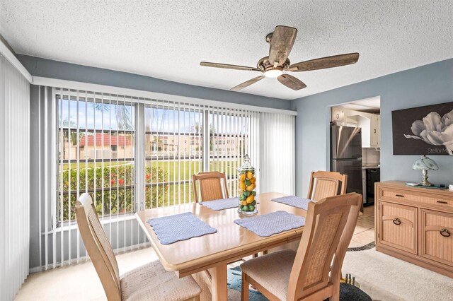 101 Dogwood Cir, Seminole, FL 33777 - dining space with plenty of natural light, a textured ceiling, a ceiling fan, and light tile patterned flooring