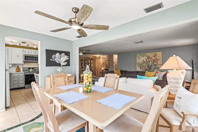 101 Dogwood Cir, Seminole, FL 33777 - dining area featuring visible vents, a textured ceiling, a ceiling fan, and light tile patterned flooring