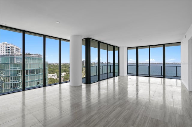 2912 W Santiago St Unit 1401, Tampa, FL 33629 - unfurnished room with a wall of windows, a water view, and plenty of natural light