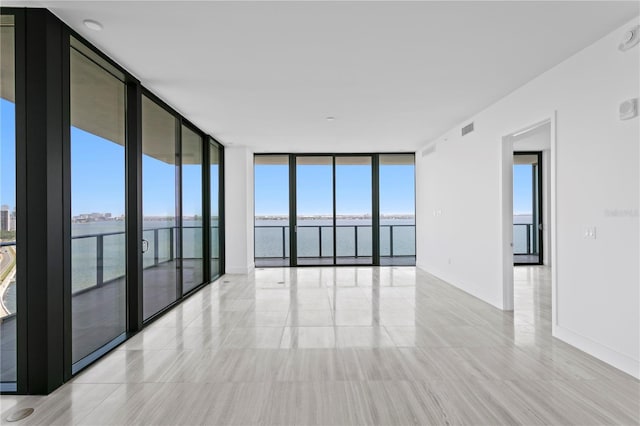 2912 W Santiago St Unit 1401, Tampa, FL 33629 - empty room with visible vents, floor to ceiling windows, a water view, and baseboards