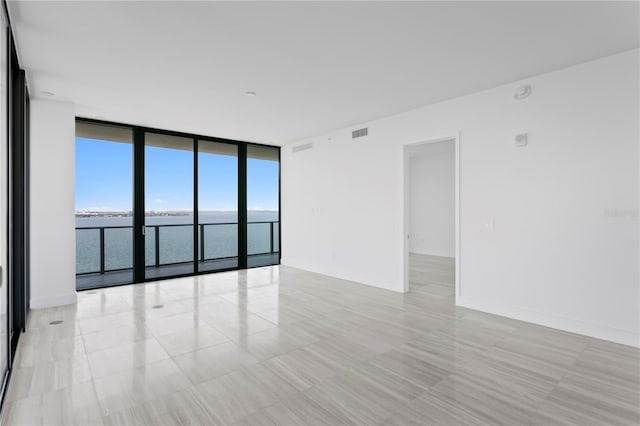 2912 W Santiago St Unit 1401, Tampa, FL 33629 - unfurnished room with a water view, baseboards, a wall of windows, and visible vents