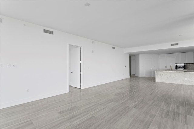 2912 W Santiago St Unit 1401, Tampa, FL 33629 - unfurnished living room with baseboards and visible vents