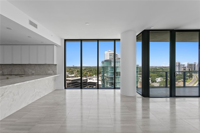 2912 W Santiago St Unit 1401, Tampa, FL 33629 - spare room with light tile patterned floors, a view of city, expansive windows, and visible vents