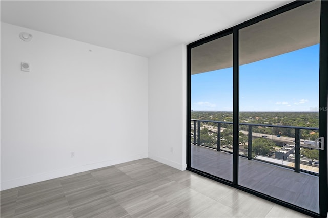 2912 W Santiago St Unit 1401, Tampa, FL 33629 - tiled spare room featuring baseboards and expansive windows