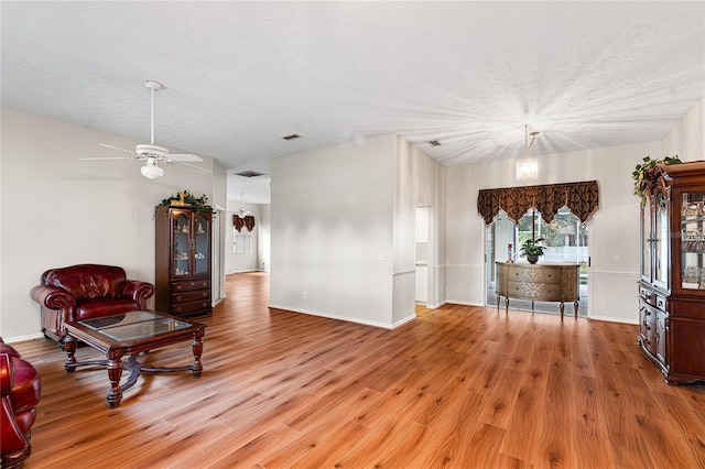 2803 Bent Leaf Dr, Valrico, FL 33594 - living area with a ceiling fan, wood finished floors, a textured ceiling, and baseboards