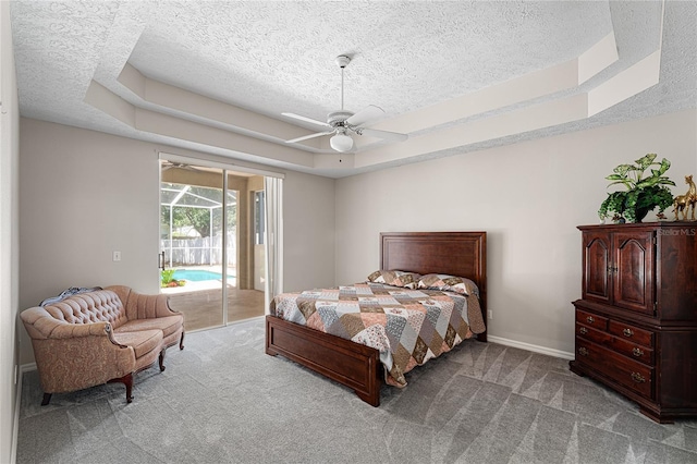 2803 Bent Leaf Dr, Valrico, FL 33594 - carpeted bedroom featuring a tray ceiling, access to outside, a textured ceiling, a ceiling fan, and baseboards