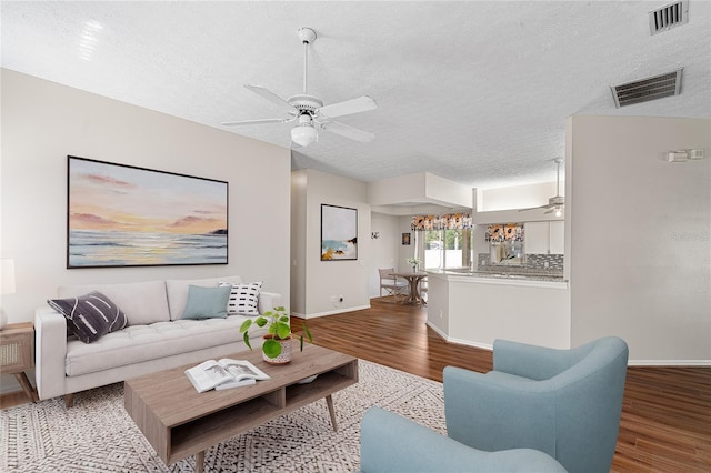 2803 Bent Leaf Dr, Valrico, FL 33594 - living area with a ceiling fan, wood finished floors, a textured ceiling, and baseboards