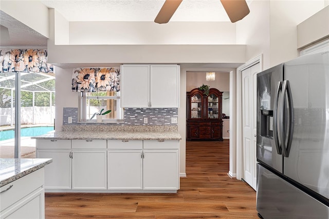 2803 Bent Leaf Dr, Valrico, FL 33594 - kitchen with stainless steel refrigerator with ice dispenser, light wood finished floors, tasteful backsplash, ceiling fan, and a textured ceiling
