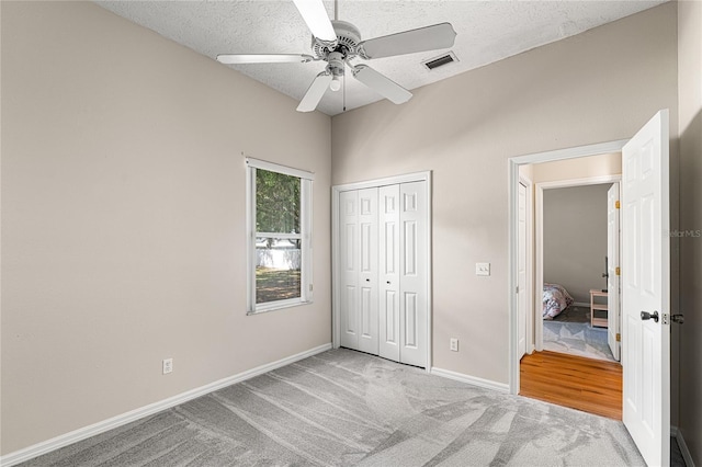 2803 Bent Leaf Dr, Valrico, FL 33594 - unfurnished bedroom with carpet flooring, a closet, baseboards, a textured ceiling, and ceiling fan