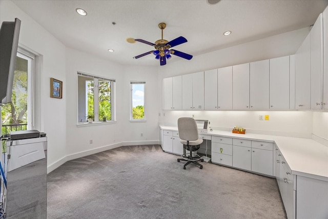 1058 Roundstone Pl, Palm Harbor, FL 34683 - office space with light carpet, built in desk, ceiling fan, and recessed lighting