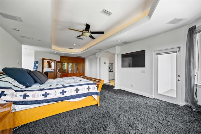 1058 Roundstone Pl, Palm Harbor, FL 34683 - carpeted bedroom featuring ornate columns, a raised ceiling, and recessed lighting