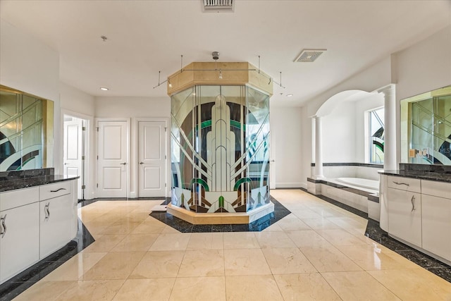 1058 Roundstone Pl, Palm Harbor, FL 34683 - bathroom with decorative columns, a garden tub, a shower stall, vanity, and recessed lighting