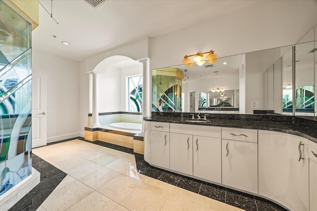 1058 Roundstone Pl, Palm Harbor, FL 34683 - full bathroom with decorative columns, a garden tub, vanity, and recessed lighting