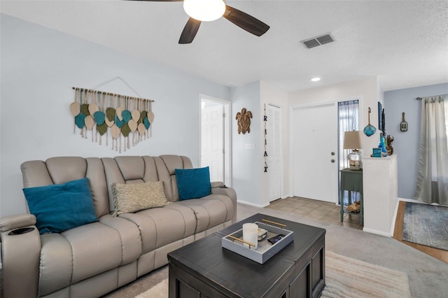 1657 Glengarry Dr, Palm Harbor, FL 34684 - living room with visible vents, a ceiling fan, baseboards, and light carpet