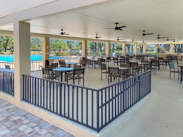 1657 Glengarry Dr, Palm Harbor, FL 34684 - view of patio featuring a ceiling fan, a community pool, and fence