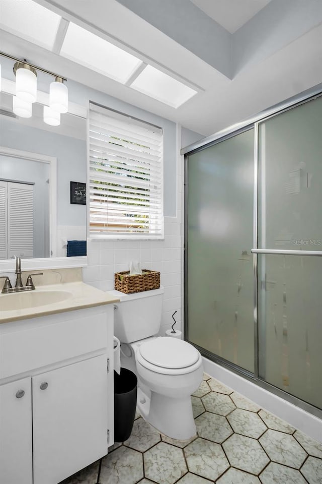 1657 Glengarry Dr, Palm Harbor, FL 34684 - full bath featuring tile walls, tile patterned flooring, a shower stall, vanity, and toilet