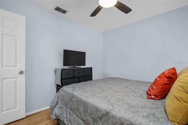 1657 Glengarry Dr, Palm Harbor, FL 34684 - bedroom with a ceiling fan, baseboards, visible vents, and wood finished floors