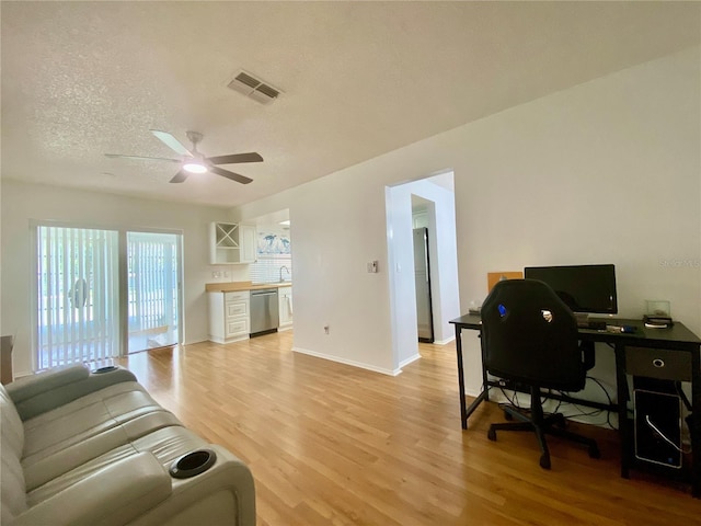 1657 Glengarry Dr, Palm Harbor, FL 34684 - living room with light wood-type flooring, ceiling fan, an office area, and a textured ceiling