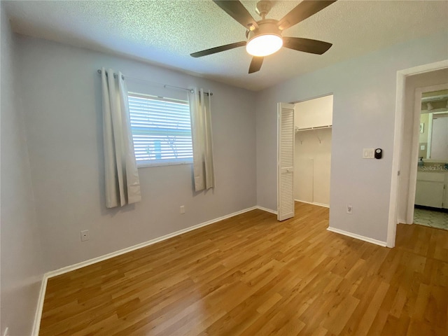 1657 Glengarry Dr, Palm Harbor, FL 34684 - unfurnished bedroom with light wood-type flooring, a closet, ceiling fan, and a textured ceiling