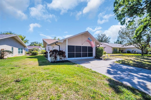 1657 Glengarry Dr, Palm Harbor, FL 34684 - view of front of home with driveway, stucco siding, a front yard, and an attached garage