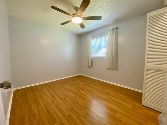 1657 Glengarry Dr, Palm Harbor, FL 34684 - unfurnished bedroom featuring wood finished floors, a ceiling fan, and a closet