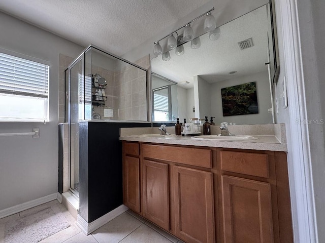 full bath featuring visible vents, a sink, and a stall shower