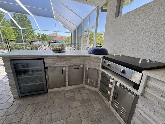 view of patio with a lanai, an outdoor kitchen, beverage cooler, and outdoor wet bar